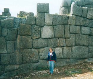 Tour guide discussing the structural form and use of this large room in Machu Picchu, Per�, noting that the perfectly constructed stones indicate that it was a sacred place for the pagans