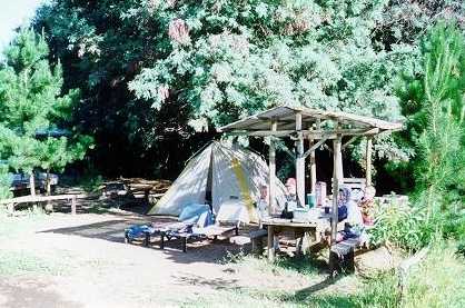 Grace, David, Joshua, and Daniel eating in front of their tent, in Salto Del Leon