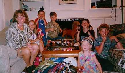 Mom watching kids open their new presents